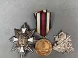 three medals and a medal on a gray surface