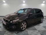 the black car is parked on a checkered floor in the garage