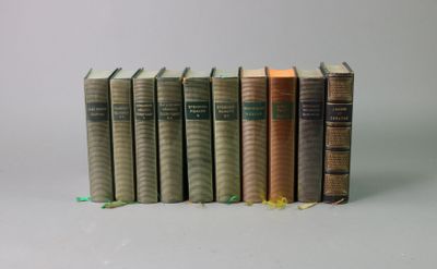 several books are stacked on top of each other on a white surface