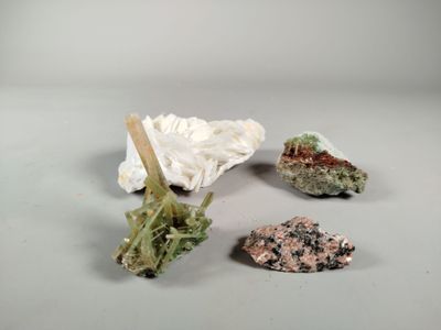 three different types of rocks on a white surface