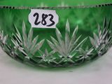 a green glass bowl with a price tag on it