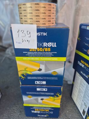 two boxes of tik roll tape sitting on a table next to each other