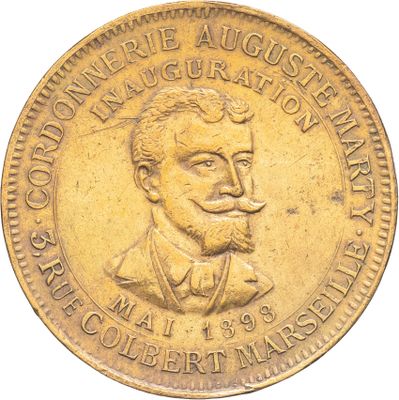 une vieille pièce de monnaie sur laquelle figure l'effigie d'un homme moustachu