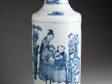 a blue and white vase with a picture of people sitting at a table