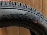 a close up of a tire on a cardboard box with a cardboard box in the background