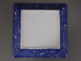 a square blue and white plate with a blue border