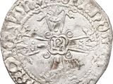 a close up of a coin with a cross on it