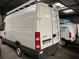 many white vans parked in a garage with their doors open