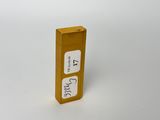 an image of a small yellow box with a sticker on it