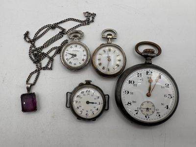 many different types of pocket watches on the table