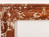 an image of a marble fireplace surround with a white wall in the background