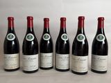 six bottles of wine are lined up on a table