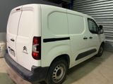 a white van parked in a garage with the door open