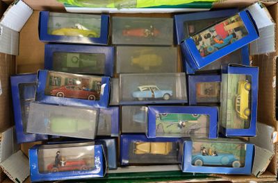 a cardboard box full of toy cars and other toys
