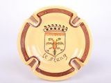 an image of a yellow ashtray with a picture of a coat of arms on it