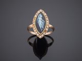 a gold ring with an image of a woman on it