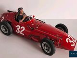 a red model of a race car with a man in the driver seat