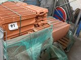 a large pile of bricks sitting on a pallet in a warehouse