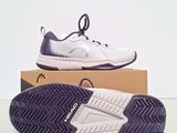 a pair of white and purple tennis shoes sitting on top of a box