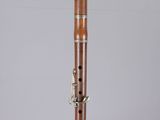 a close up of a wooden flute on a clear surface