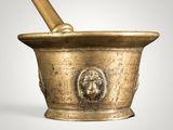 brass mortar and pestula with a lion head on the top