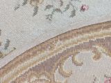 the rug is on a wooden floor with a cat laying on top of it