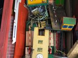 a box full of toys and a clock on the floor