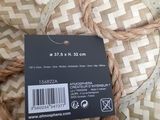 a label on a wicker basket with a tag attached to it