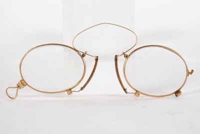 pair of glasses with gold rims on a white background