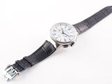 a watch that is sitting on a white surface