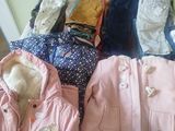 a pile of clothes sitting on top of a bed