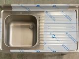 a stainless steel sink with a drain in it