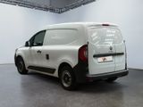 a white van with a black stripe parked in a room