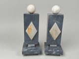 pair of marble bookends with marble balls on top of them