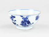 a blue and white bowl with flowers on it
