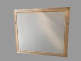 a mirror with a wooden frame on the wall