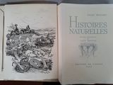an open book with a picture of a village in the background
