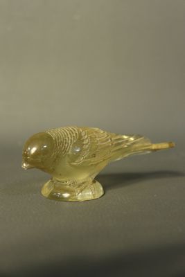 une figurine d'oiseau jaune posée sur une table