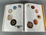 an open book with a bunch of buttons on it