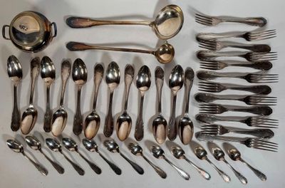 many spoons and forks laid out on the table