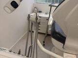 an image of a dentist ' s office with a sink and a chair