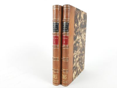 two books sitting on top of each other on a white surface