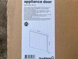 packaging for a new appliance door in a cardboard box on the ground