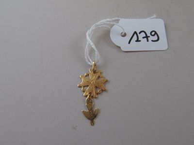 a close up of a gold plated seahorse charm on a string
