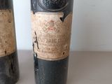two bottles of wine sitting next to each other on a table