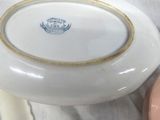 a white bowl with a gold rim sitting on a table