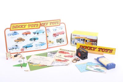a box of toy cars and other items on a white surface