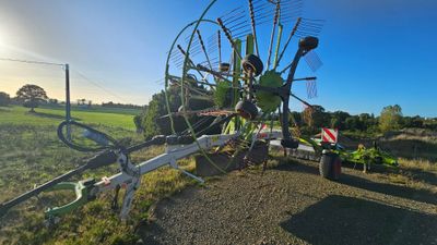 a man that is standing next to a bike and a windmill