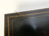a black table with a gold border on it
