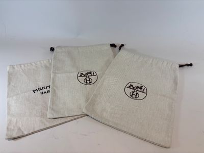 three small bags with a logo on them sitting on a table